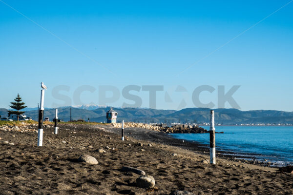 A blue sky winter morning at the Perfume Point Reserve beach, Ahuriri, Napier, Hawke’s Bay, New Zealand - SCP Stock