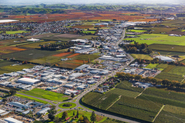 Aerial view looking up Omahu Road and over industrial land towards Flaxmere, Fernhill & Royshill from above SH2, Hastings, Hawke’s Bay, New Zealand - SCP Stock