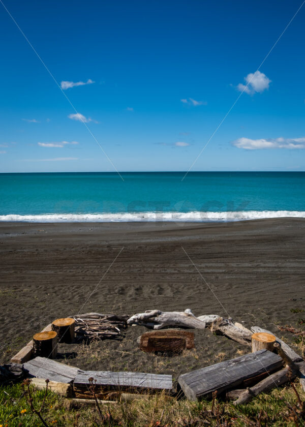 Beach fire pit and driftwood seats, Hawke’s Bay, New Zealand - SCP Stock