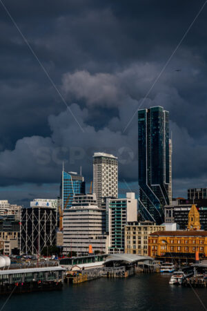 Downtown Ferry Terminal & Auckland CBD during stormy weather - SCP Stock