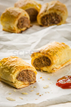 Freshly baked sausage rolls and tomato sauce - SCP Stock