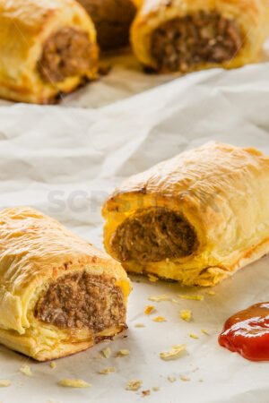 Freshly baked sausage rolls and tomato sauce - SCP Stock