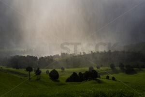 Heavy rain falling on farmland, Hawke’s Bay, New Zealand - SCP Stock