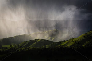 Heavy rain falling on farmland, Hawke’s Bay, New Zealand - SCP Stock