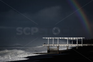 Napier’s viewing platform/outfall with a rainbow above on a stormy Winter morning, Hawke’s Bay, New Zealand - SCP Stock