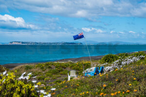 New Zealand Flag and chairs on the beach, Napier, Hawke’s Bay, New Zealand - SCP Stock