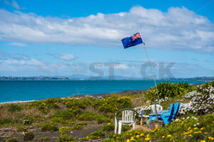 New Zealand Flag and chairs on the beach, Napier, Hawke’s Bay, New Zealand - SCP Stock