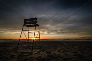 Surf lifesaving chair at sunrise, Ocean Beach, Hawke’s Bay, New Zealand - SCP Stock