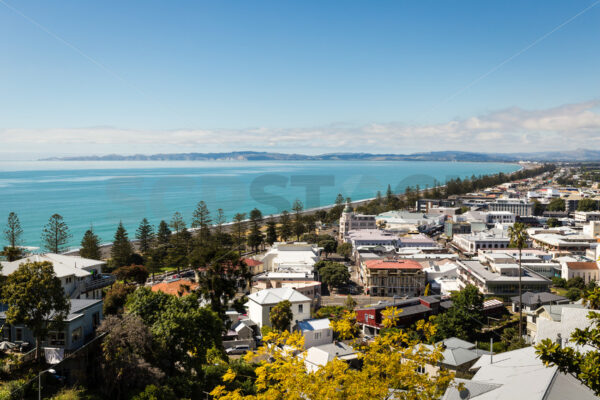 View looking over Napier’s CBD & Marine Parade with the ocean and Cape Kidnappers in the distance, Napier, Hawke’s Bay, New Zealand - SCP Stock