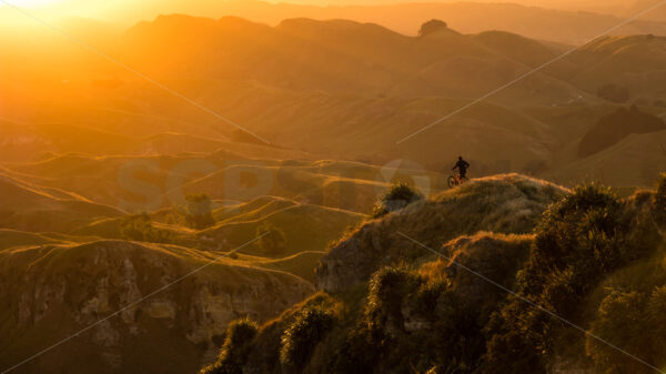 A mountain biker on Te Mata Peak at sunset, Hawke’s Bay, New Zealand - SCP Stock