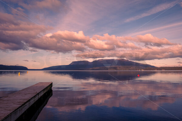 Lake Tarawera jetty with Mount Tarawera in the distance, Rotorua, Bay of Plenty, New Zealand - SCP Stock