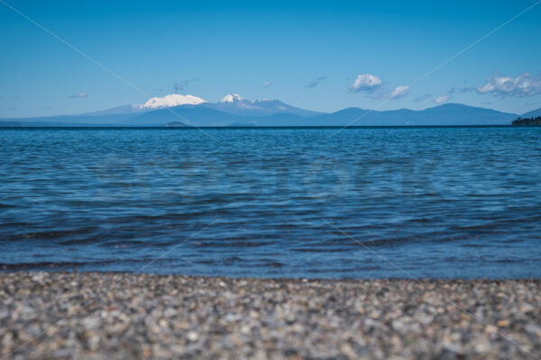 The view over Lake Taupo view towards Mount Ngauruhoe & Ruapehu from Taupo, Waikato, New Zealand - SCP Stock