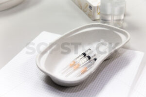 Medical syringes ready to use in a disposable cardboard kidney shaped dish - SCP Stock