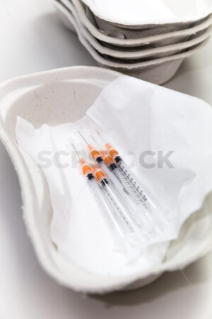 Medical syringes ready to use in a disposable cardboard kidney shaped dish - SCP Stock